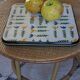 Vintage laminated wooden trivet with yellow, green, and blue flowers