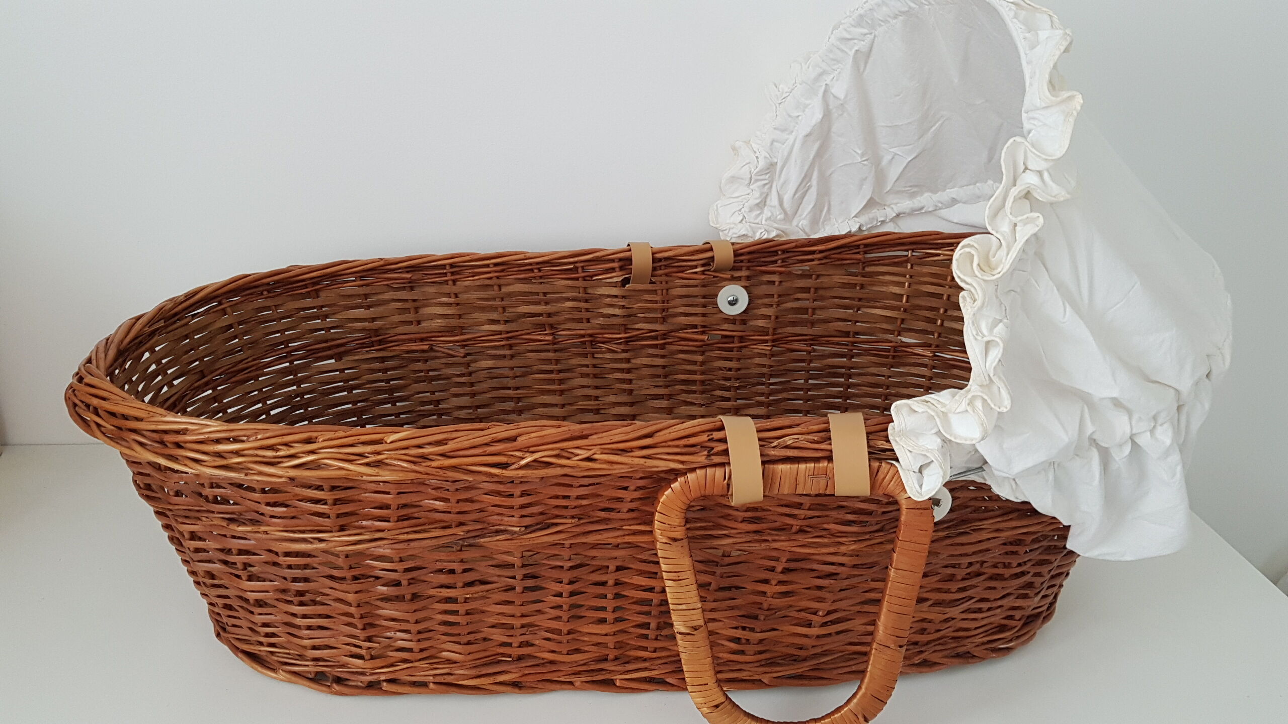 Old rattan bassinet and bedding