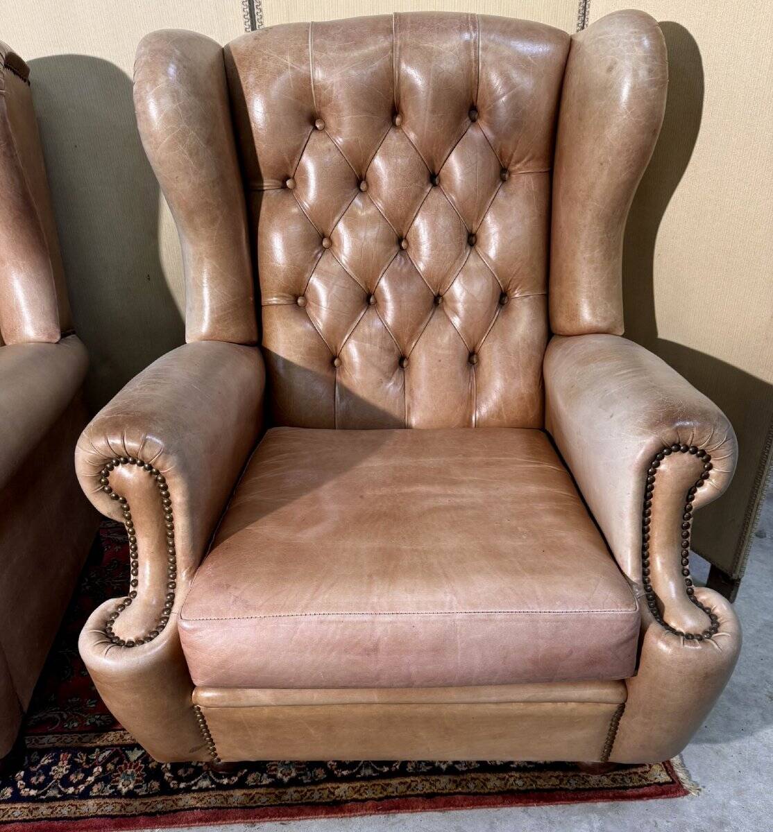 Pair of Chesterfield leather wingback armchairs