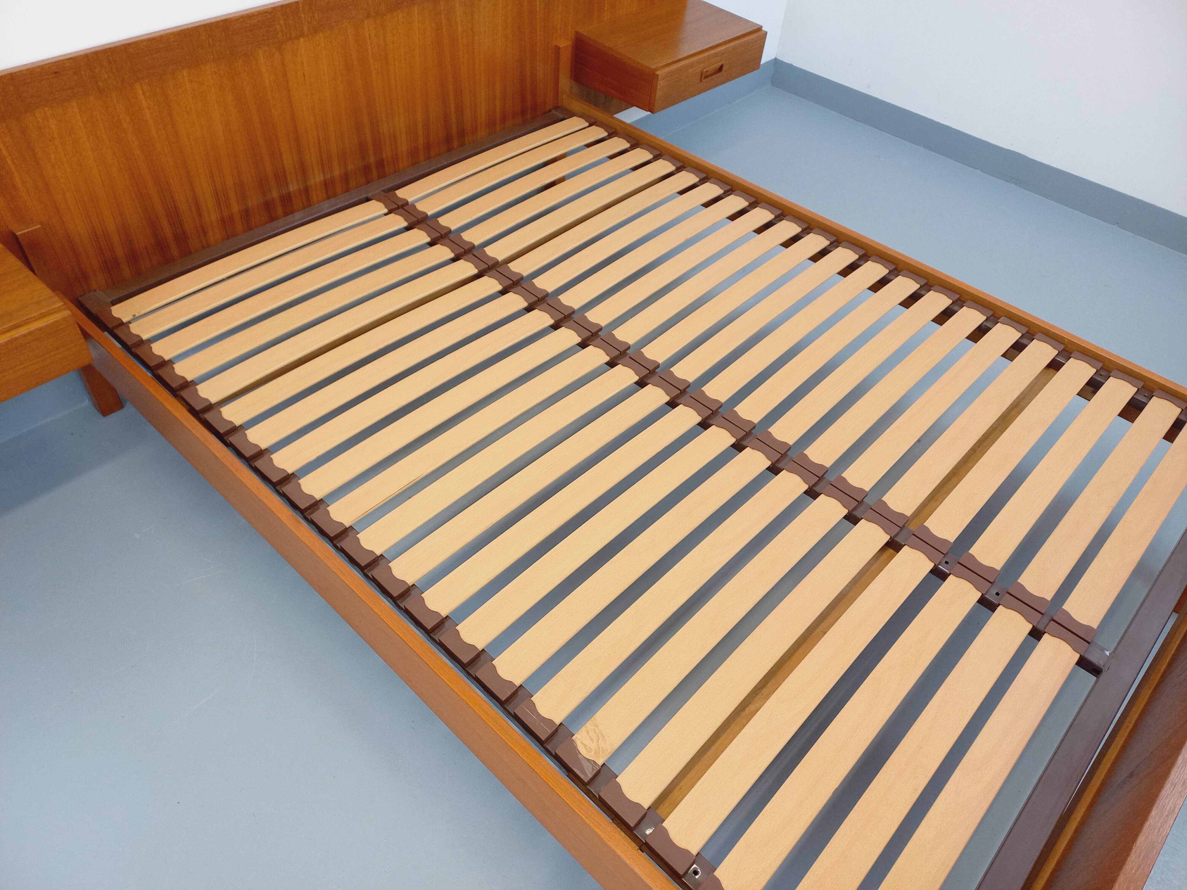 Double bed vintage Scandinavian in teak from the 1960s with integrated bedside tables.