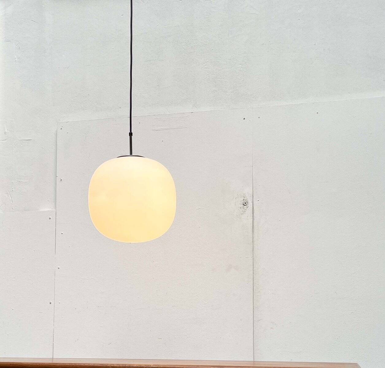 Minimalist suspended glass ball lamp from the vintage German space age by Glashütte Limburg, 1970s.