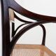 Mid-century curved wooden chairs with cane seats and backs.