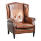 Sheepskin wingback armchair in a warm cognac colour with refined nailhead trim