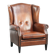Sheepskin wingback armchair in a warm cognac colour with refined nailhead trim