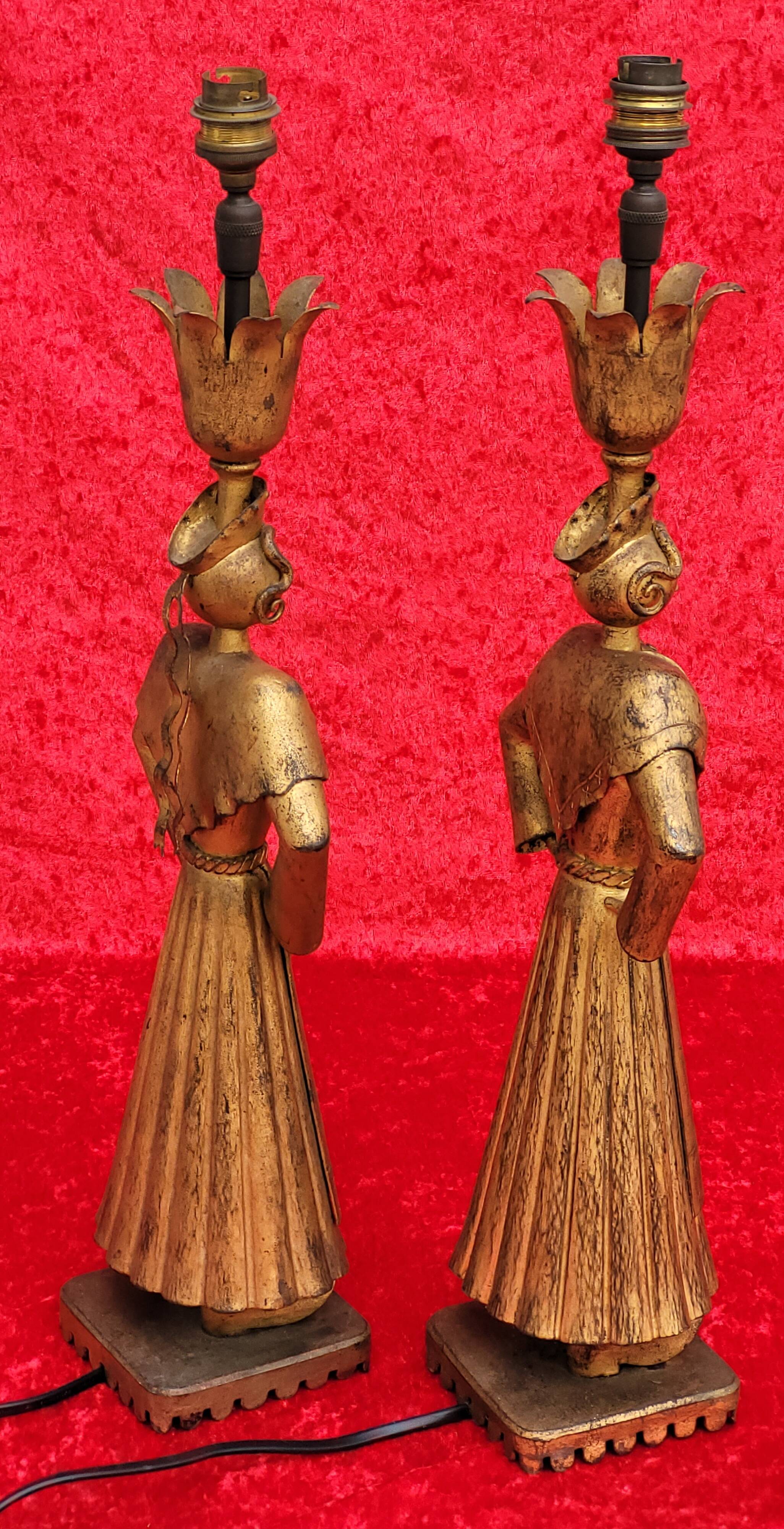 Pair of gilded beaten iron sculpture lamps attributed to Gilbert Poillerat