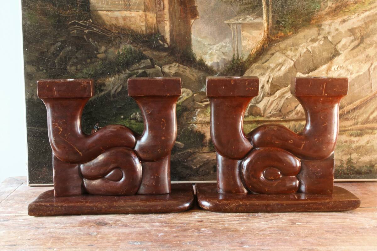 Pair of Art Deco carved wood candlesticks, signed Delaporte