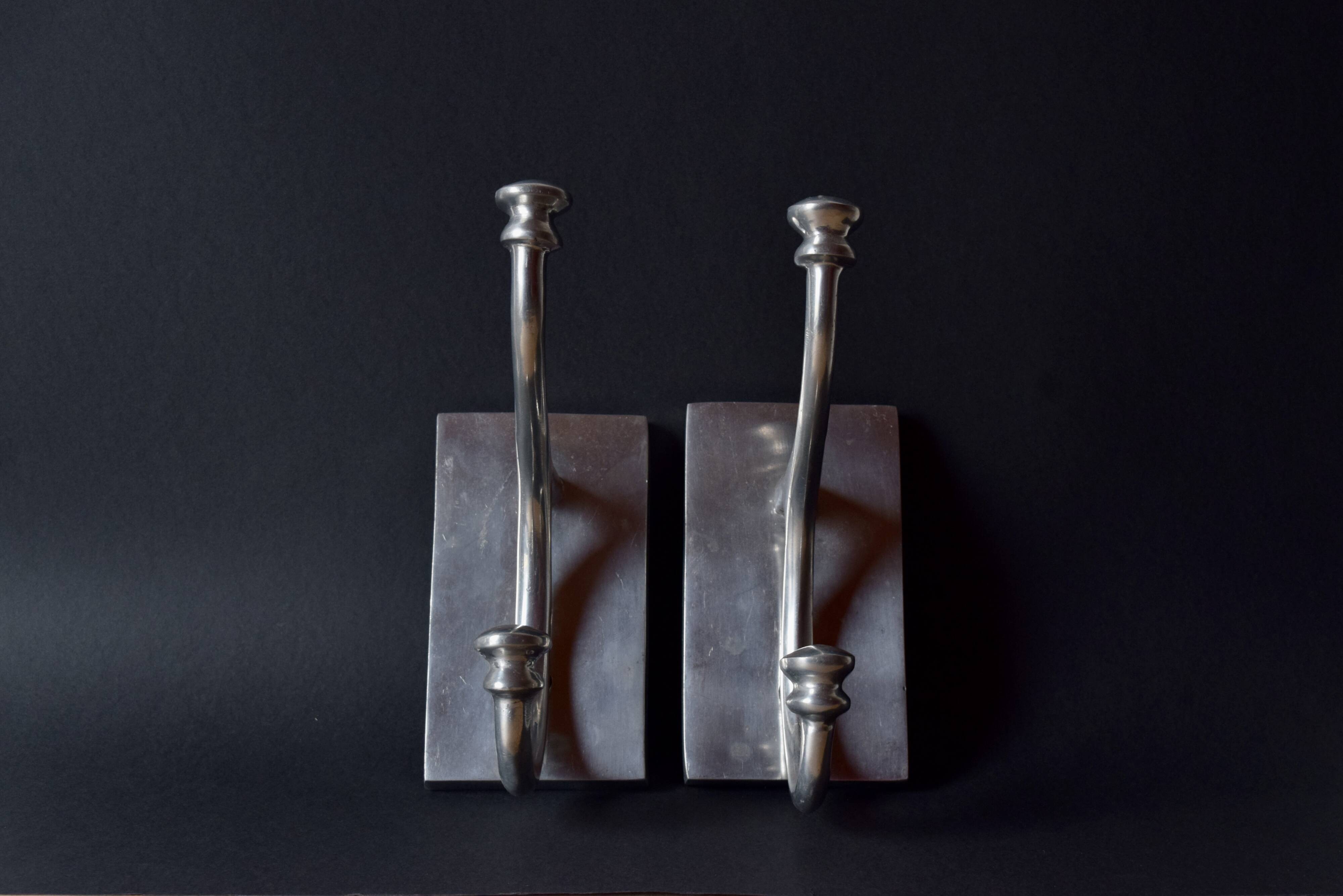 Pair of vintage cast aluminum coat hooks
