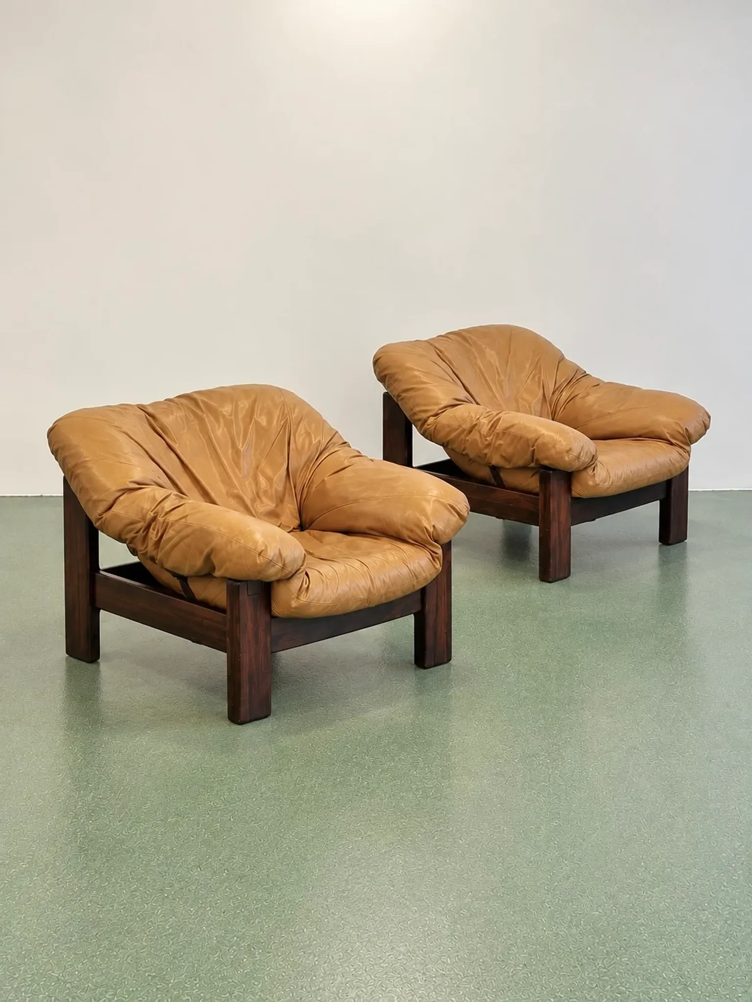 Pair of brutalist leather lounge chairs, 1960s