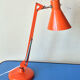 Luxo L9 orange single-arm lamp on plinth