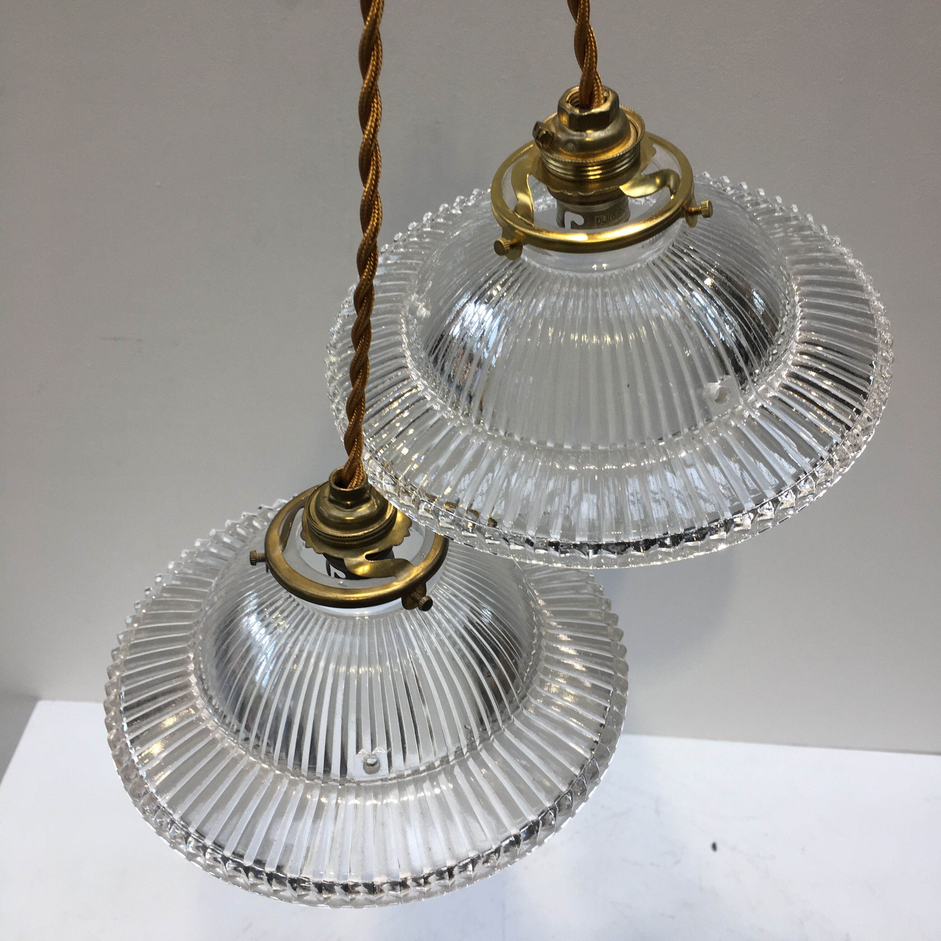 Pair of holophanous glass suspensions