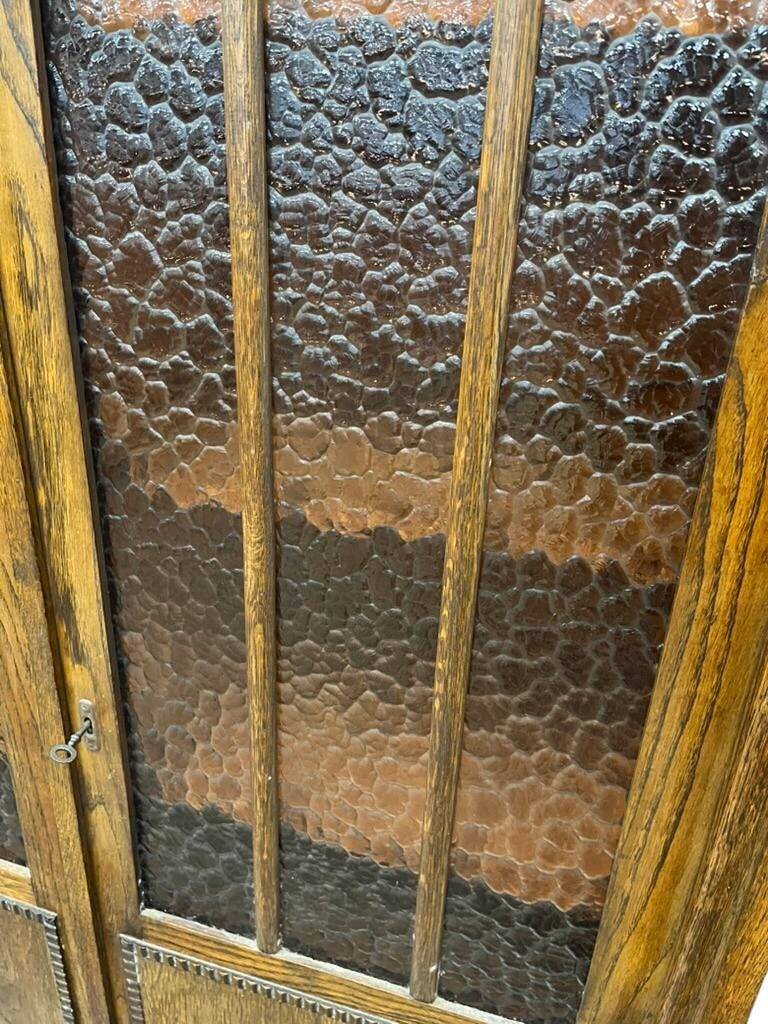 Vintage wooden display cabinet with textured glass.