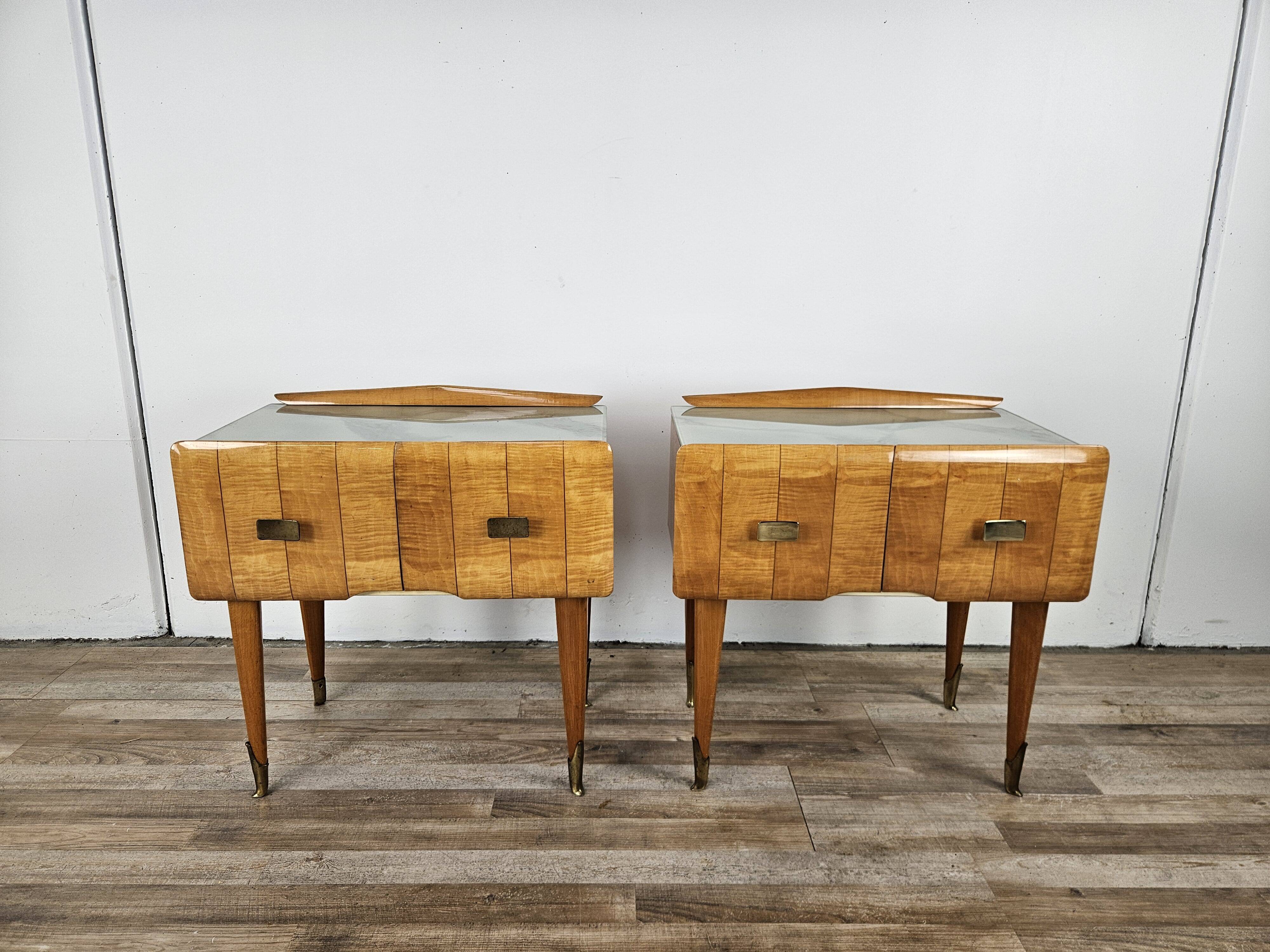 Mid-century nightstands in maple, brass, and glass