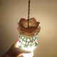 Creation of a rose on stained glass with pendants and opaline.