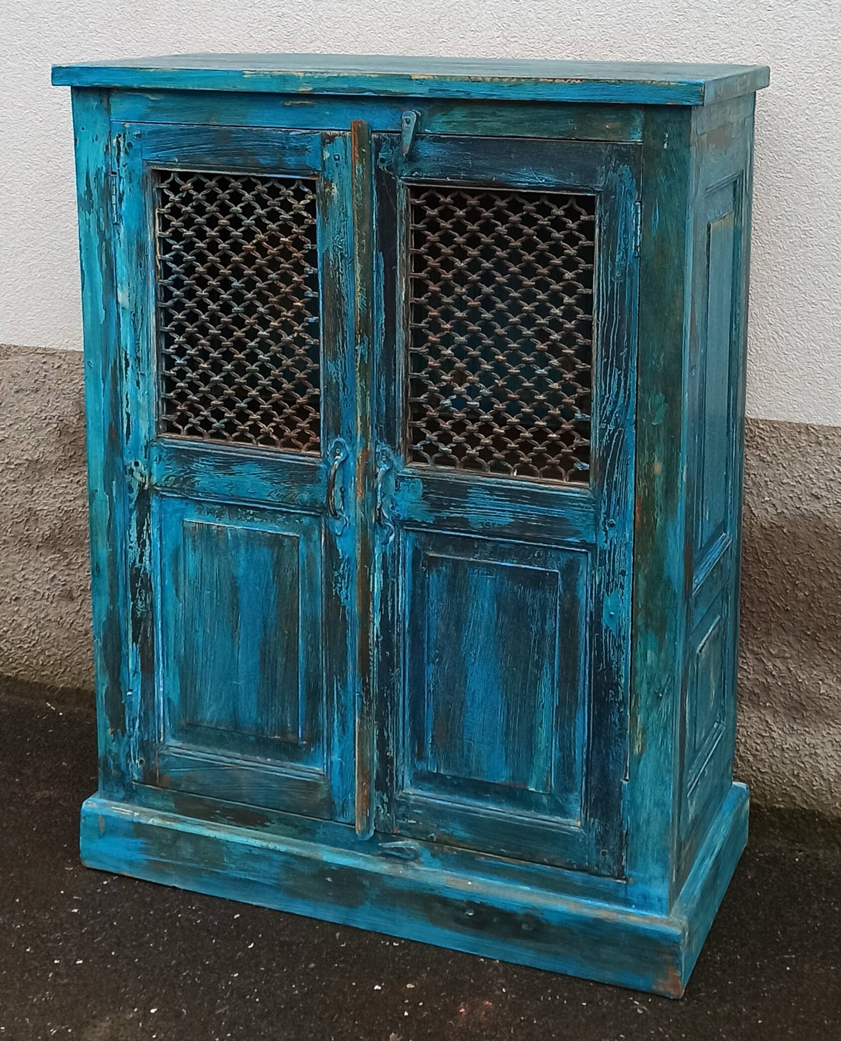 Old wooden cabinet with doors with grille