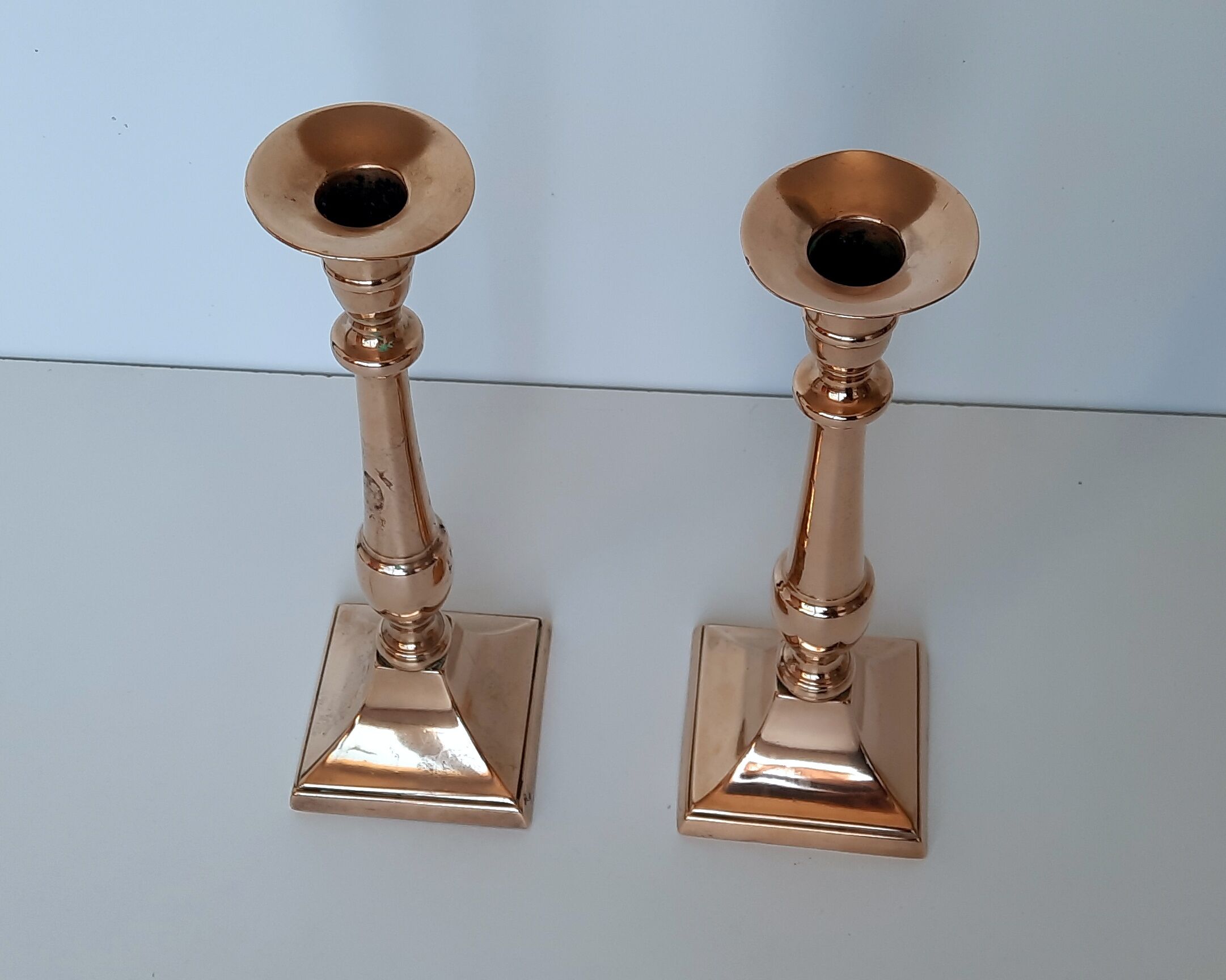 Pair of square foot copper candle holders