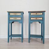 Blue wooden bedside tables with floral patterns