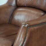Cognac brown cow leather armchair with decorative nail finish
