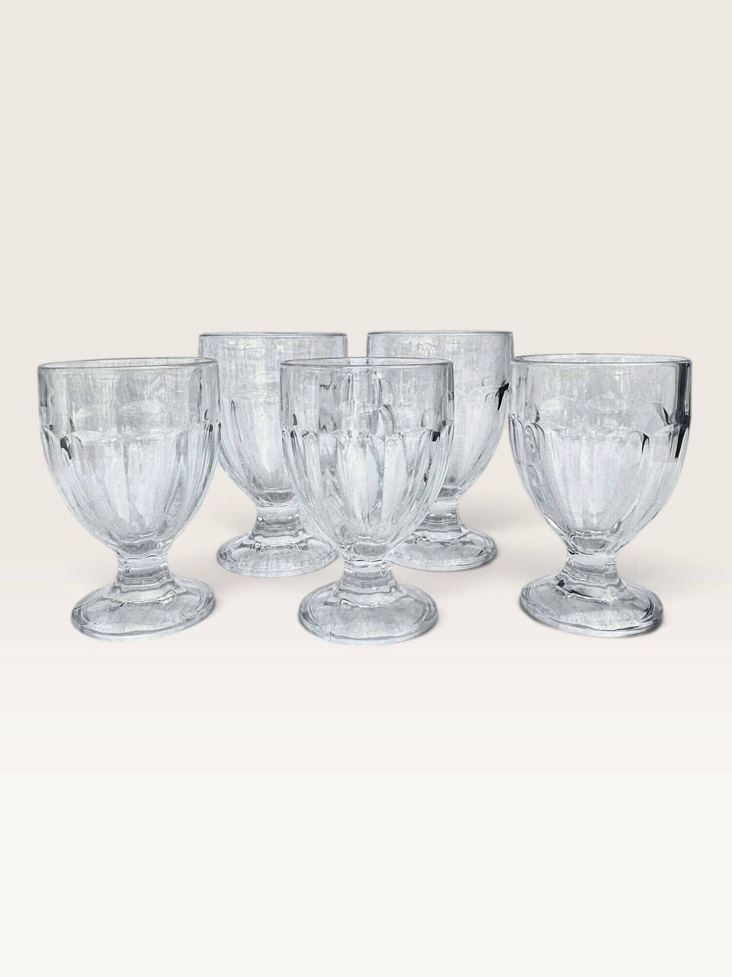 Set of 5 stemmed glasses made of pressed moulded glass.