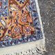 Handmade Persian rug in blue, beige, burgundy, and orange, 95x160cm.