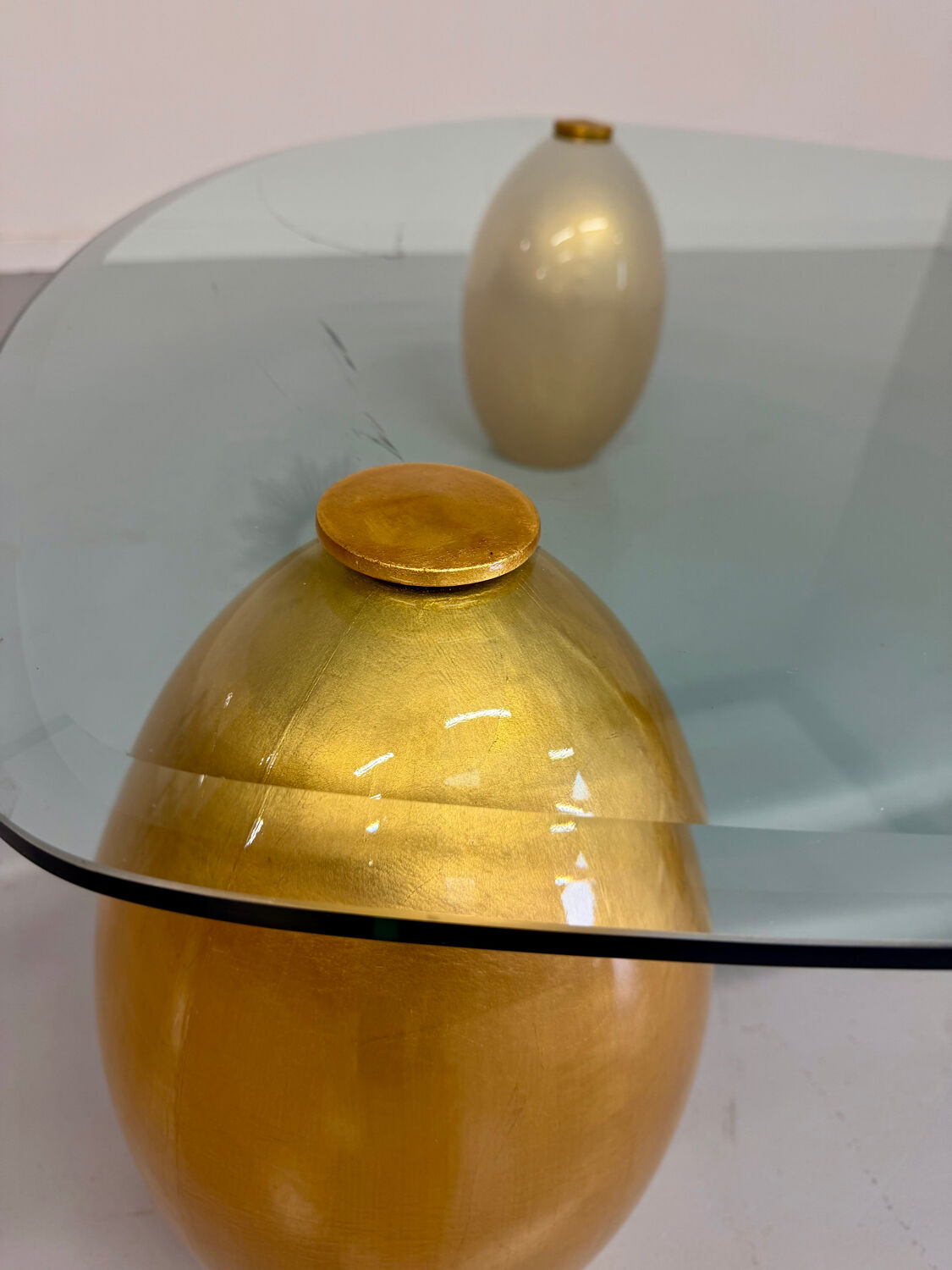 Vintage Italian design coffee table with a glass top and gold base, dating from the 1980s.