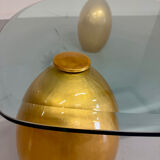 Vintage Italian design coffee table with a glass top and gold base, dating from the 1980s.