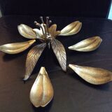 Flower of lilies wears golden 60s ashtrays