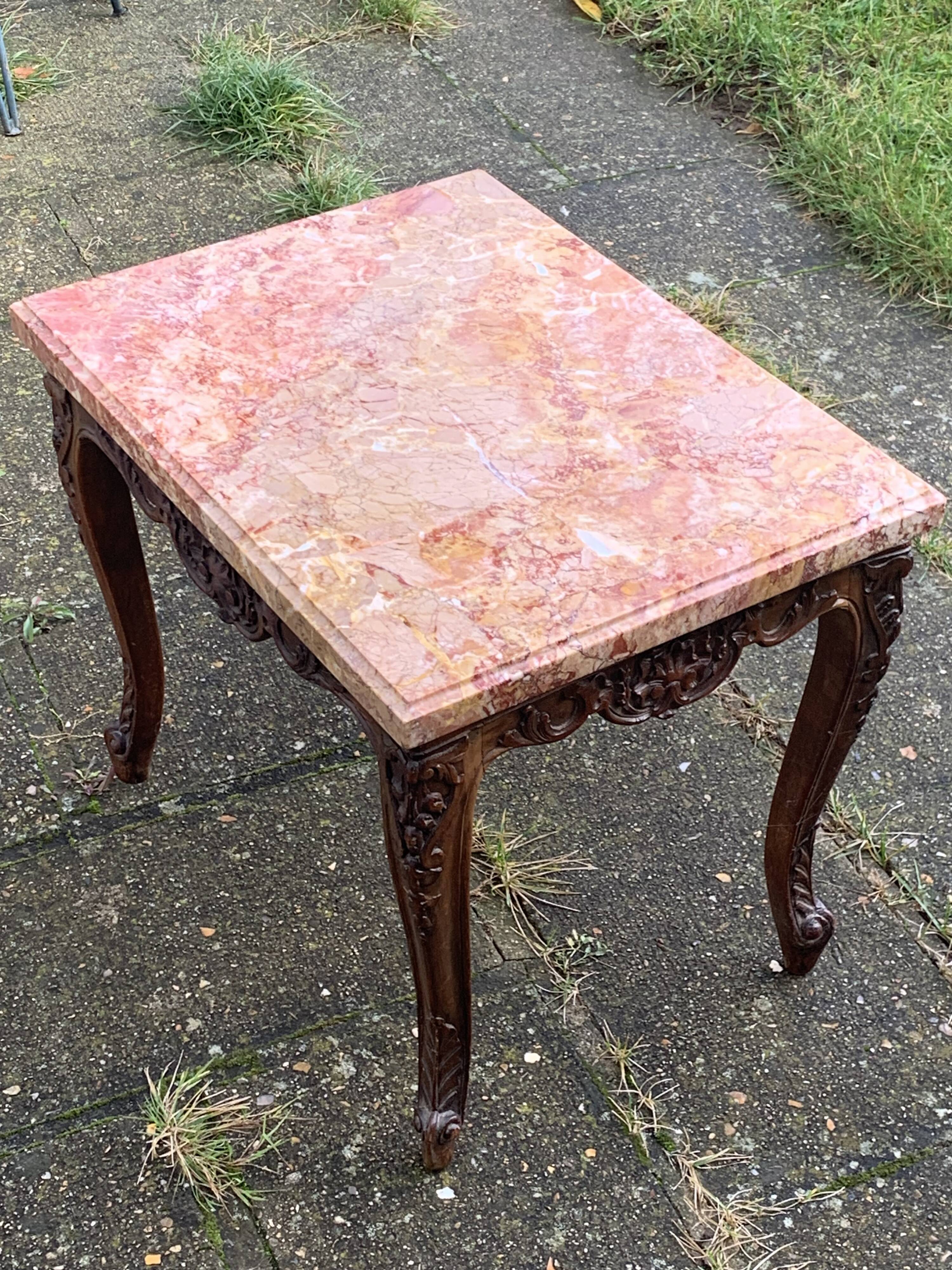 Carved wooden coffee table with shell pattern and removable pink marble top, old