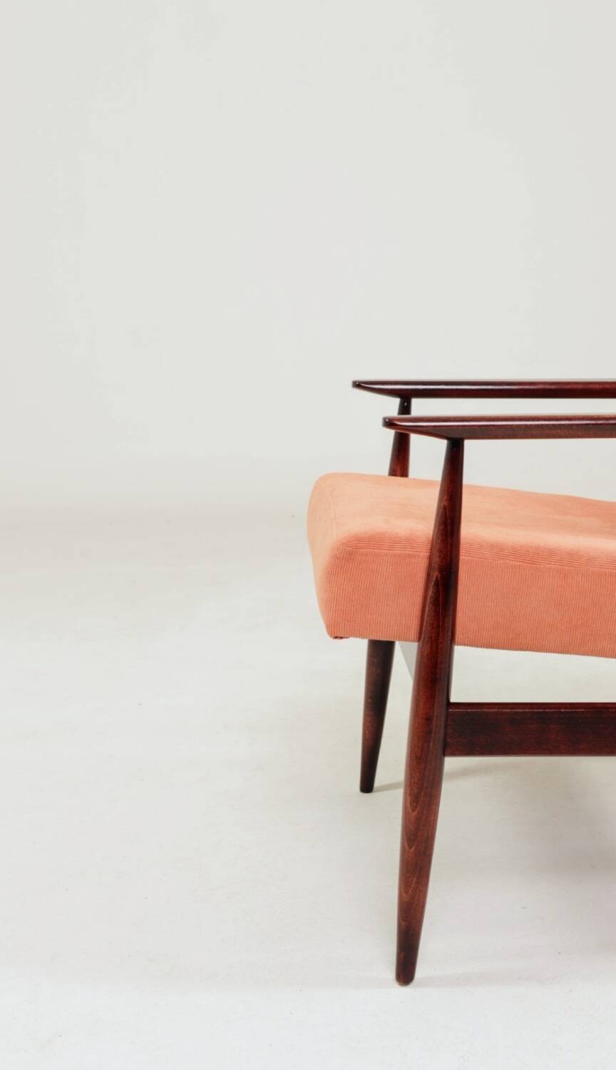 Mid-century modern armchair in coral red designed by H. Lis.