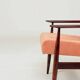 Mid-century modern armchair in coral red designed by H. Lis.