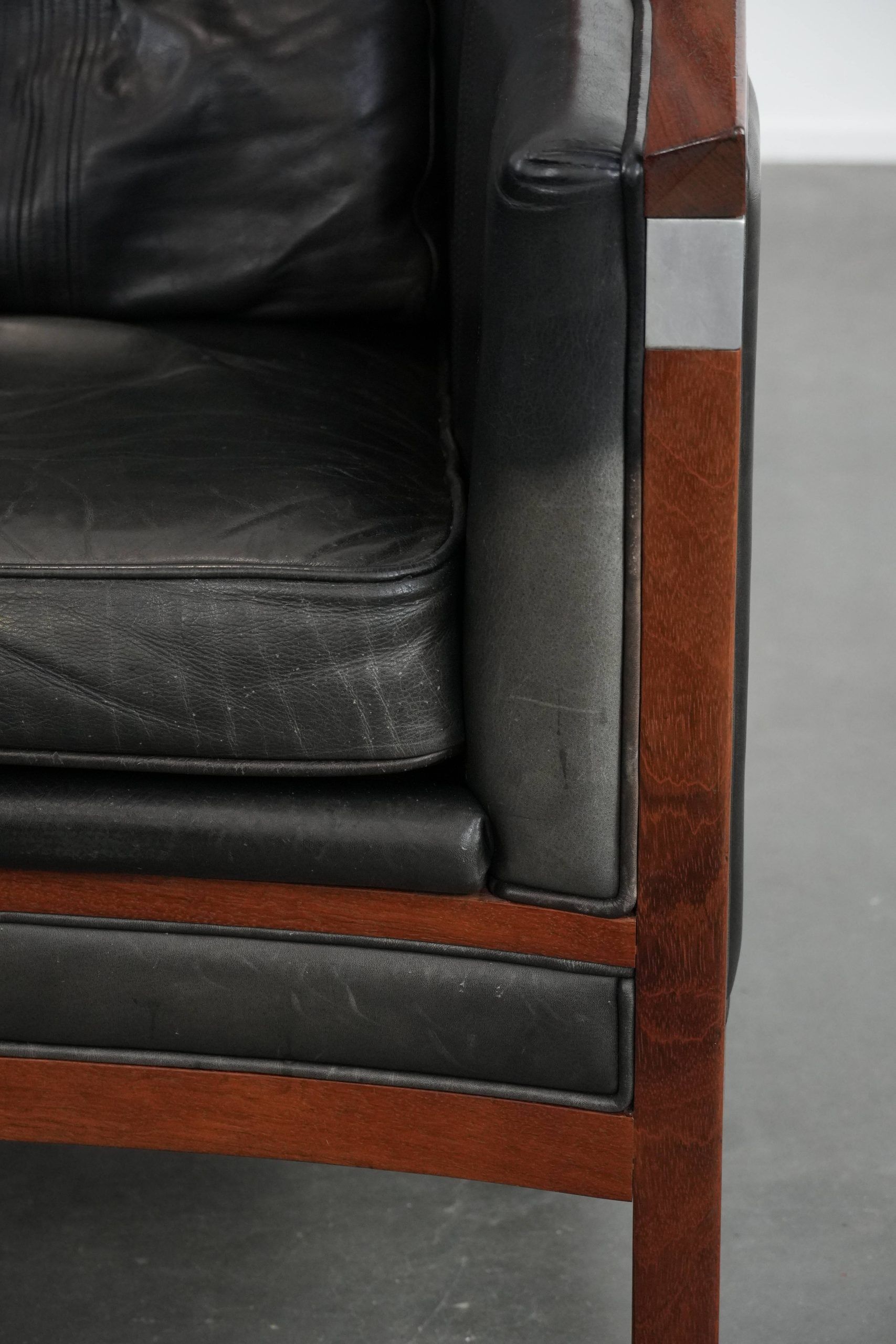 Black Art Deco cowhide leather and wooden design armchair with a high back