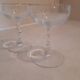 Two small crystal champagne glasses with twisted stems.