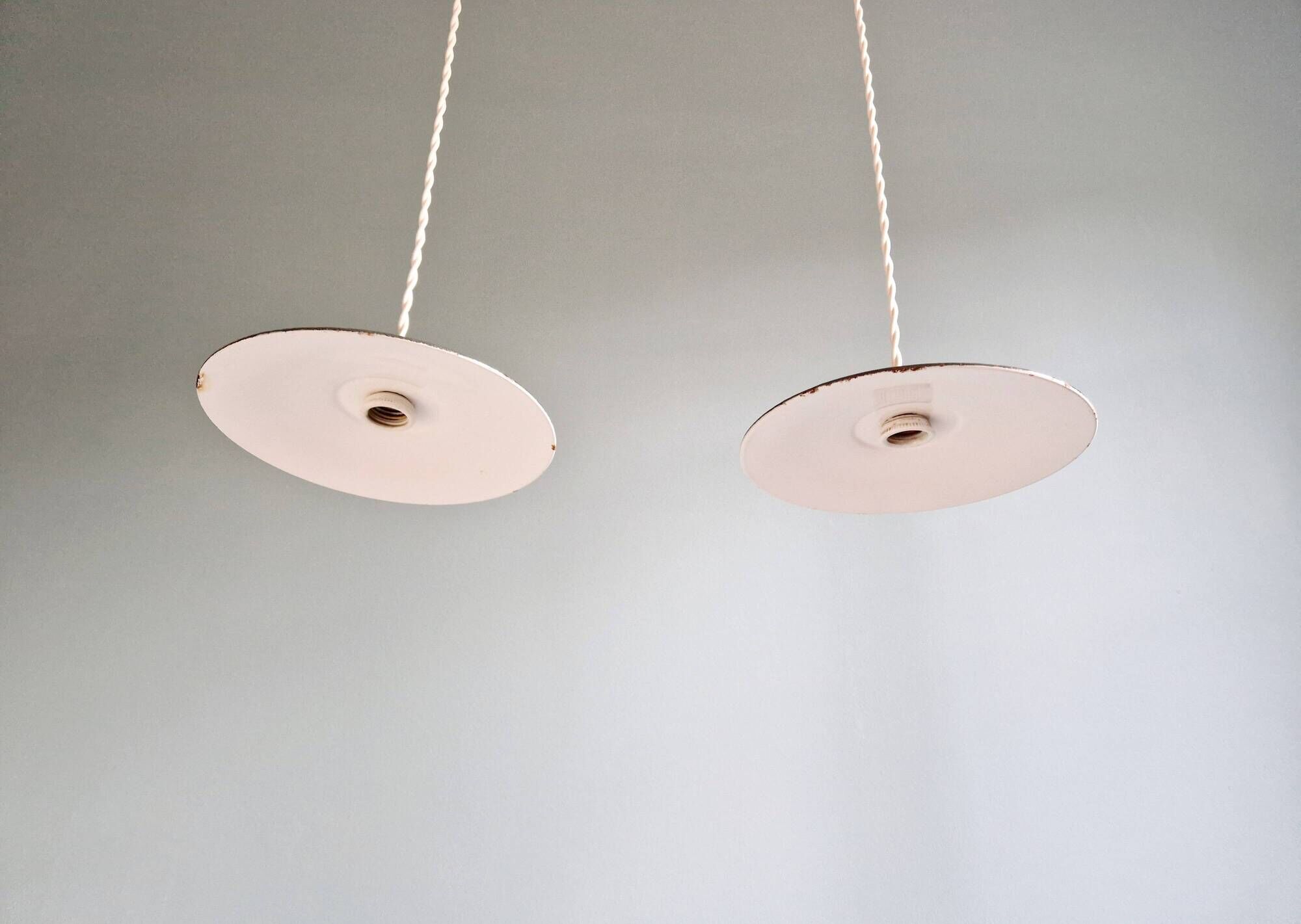 Pair of industrial pendant lights in green enamelled sheet metal