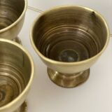 4 golden brass egg cups