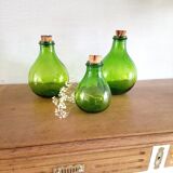 3 green glass bottles