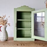 Small glass cabinet in green colour.