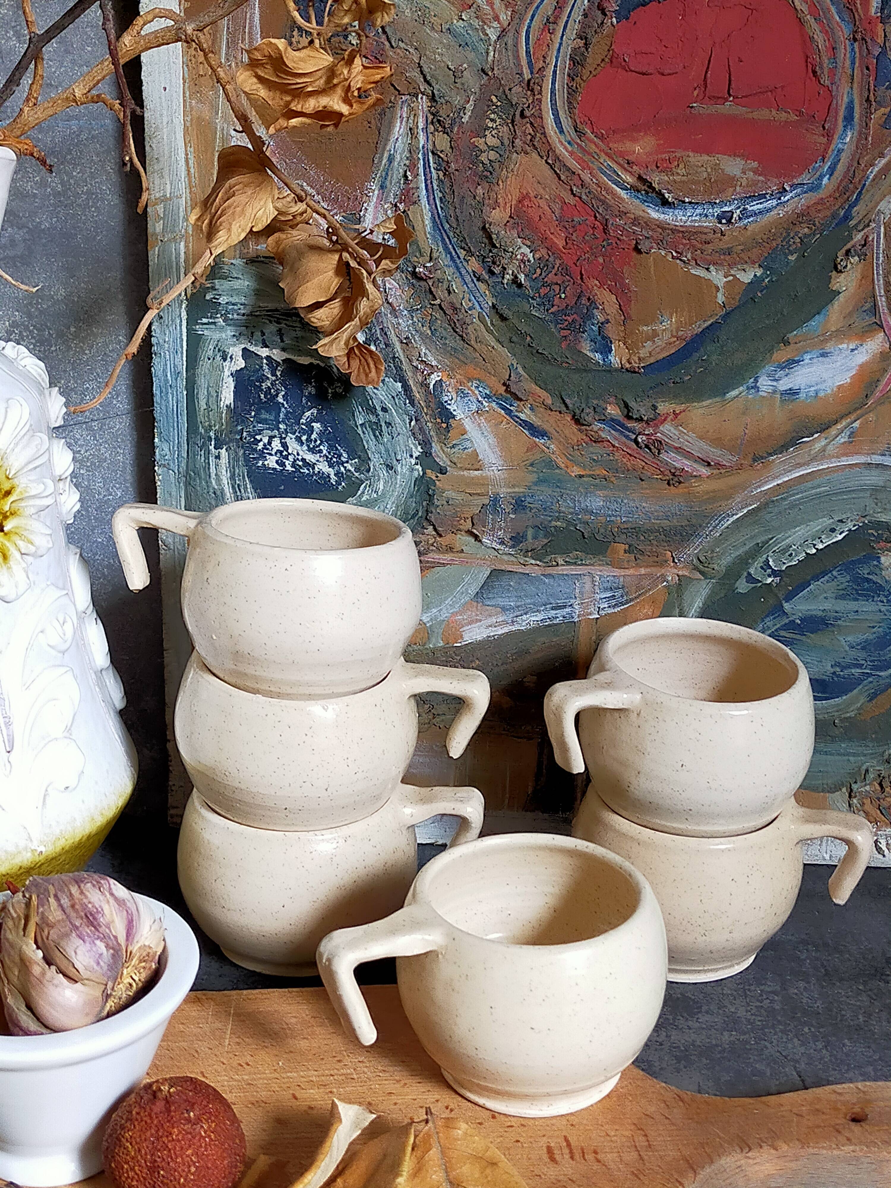 Six vintage potter's ceramic cups with vanilla enamel