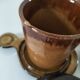 Pair of glazed stoneware cups with saucers and lids