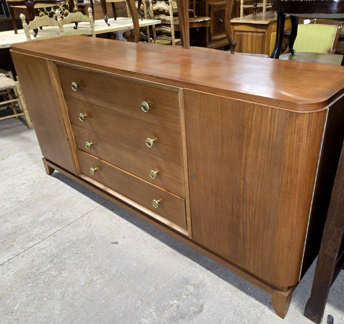 According to André Arbus, a sideboard in a row from the Art Deco period in blonde mahogany.