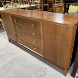 According to André Arbus, a sideboard in a row from the Art Deco period in blonde mahogany.