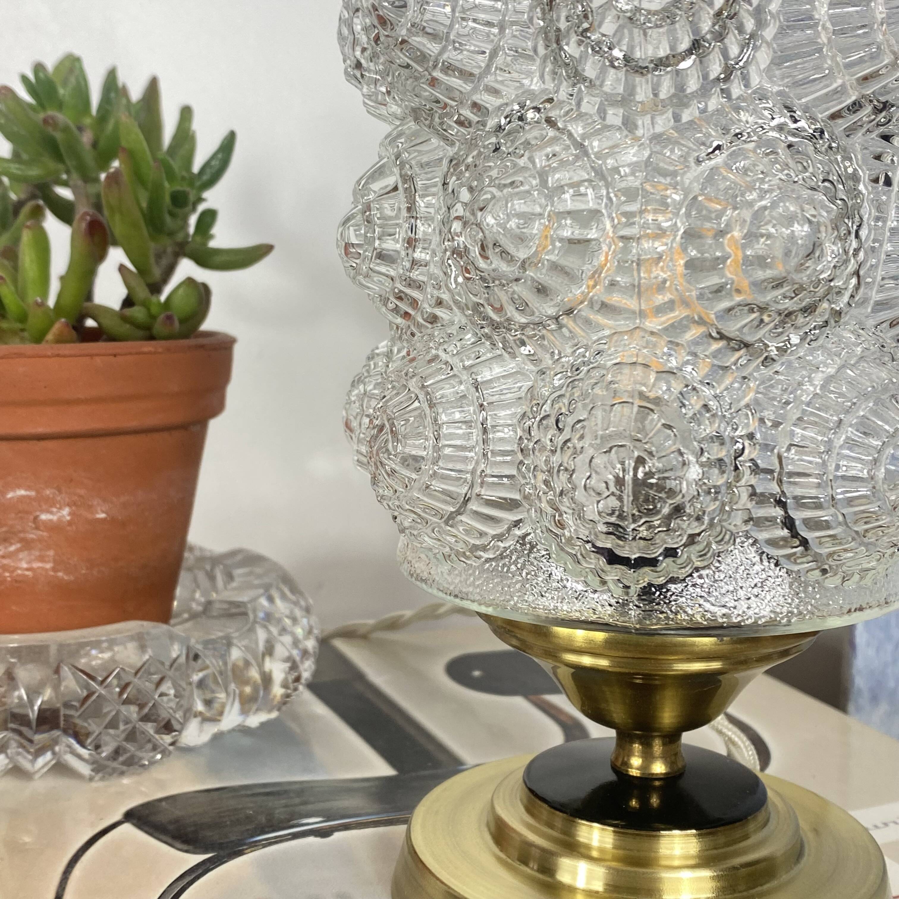 Antique globe table lamp in moulded transparent glass with a brass base.