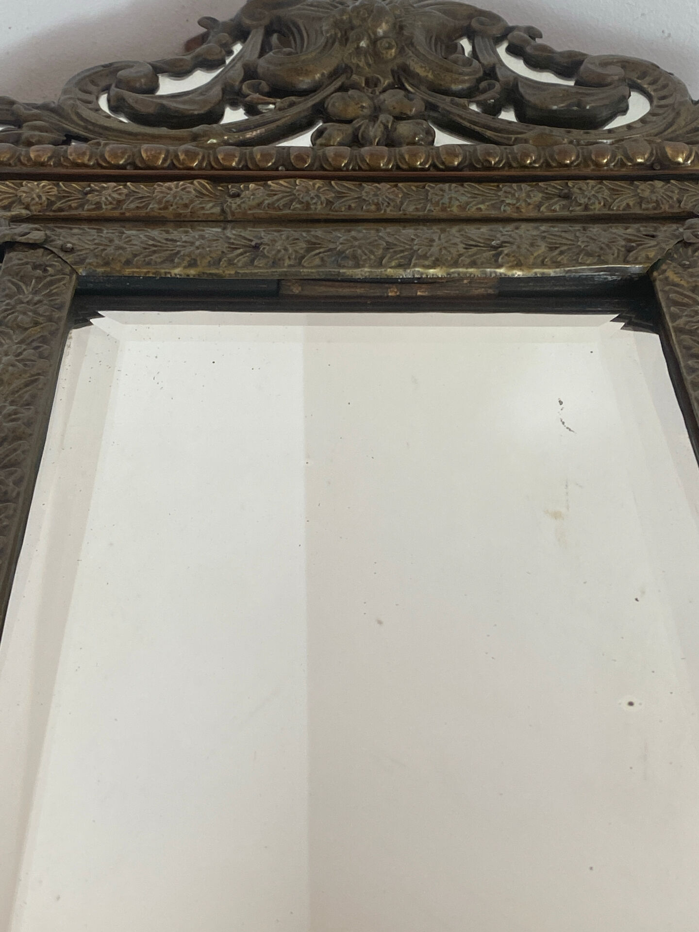 Mirror with brass repoussé frame