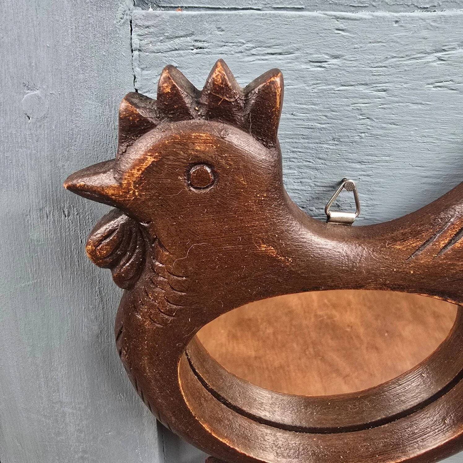 Vintage carved wooden chicken-shaped wall mirror.