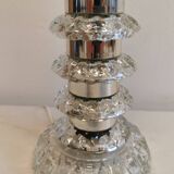 Table lamp made of transparent crystal glass and silver colored spacers.