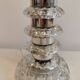 Table lamp made of transparent crystal glass and silver colored spacers.