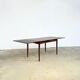 Rosewood dining table with integrated extensions — Denmark, 1960s