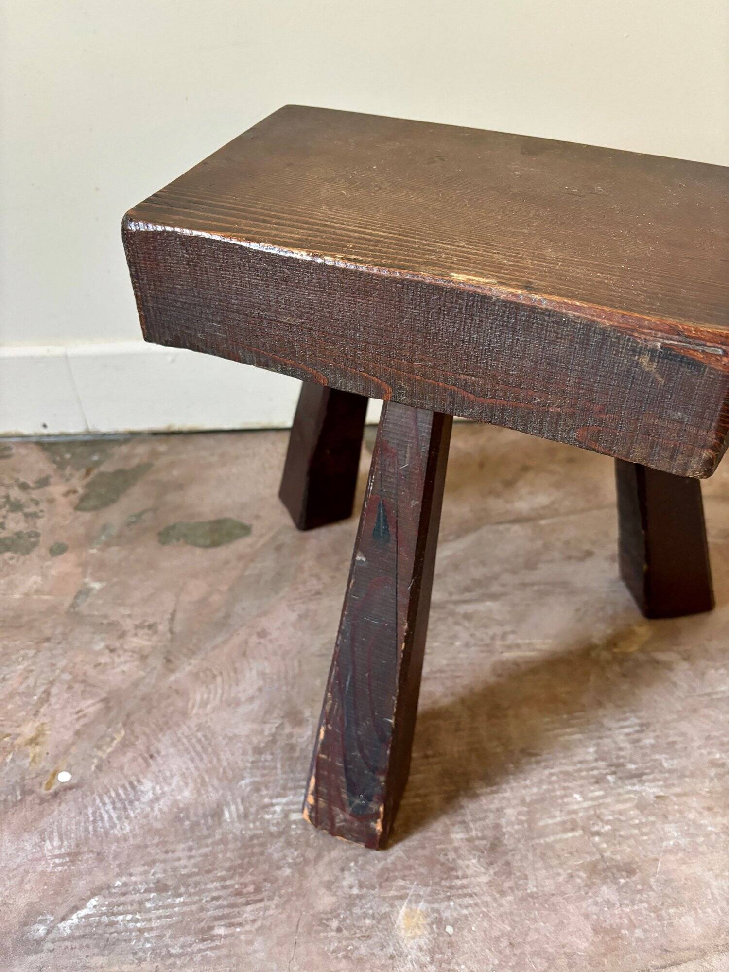 Brutalist tripod stool in dark wood