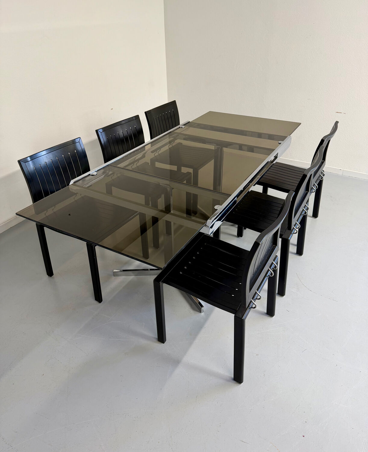 Smoked glass dining table with chrome legs, 1970s design by Roche Bobois.