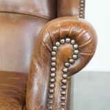 Cognac-colored sheepskin wing chair in English style