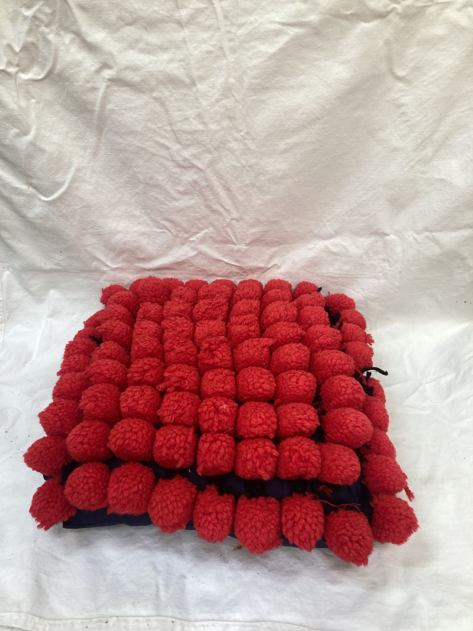 Vintage cushion red pompoms