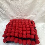 Vintage cushion red pompoms